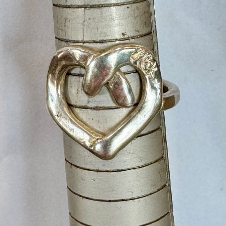 Flick Pope Cross Your Heart silver ring, front view on a ring sizer