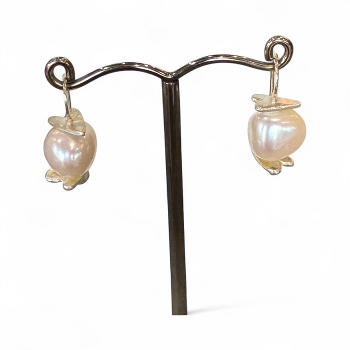 Flick Pope Oke Doke white pearl earrings on a stand