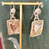 Flick Pope Postcard from the Heart earrings, brass hearts in silver frames, on a stand