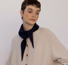 Francie Daisy merino scarf in midnight navy, tied at the neck with a cream cardigan