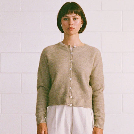 Francie Dusk cardigan in natural, a crew neck button-front knit cardigan worn with white trousers