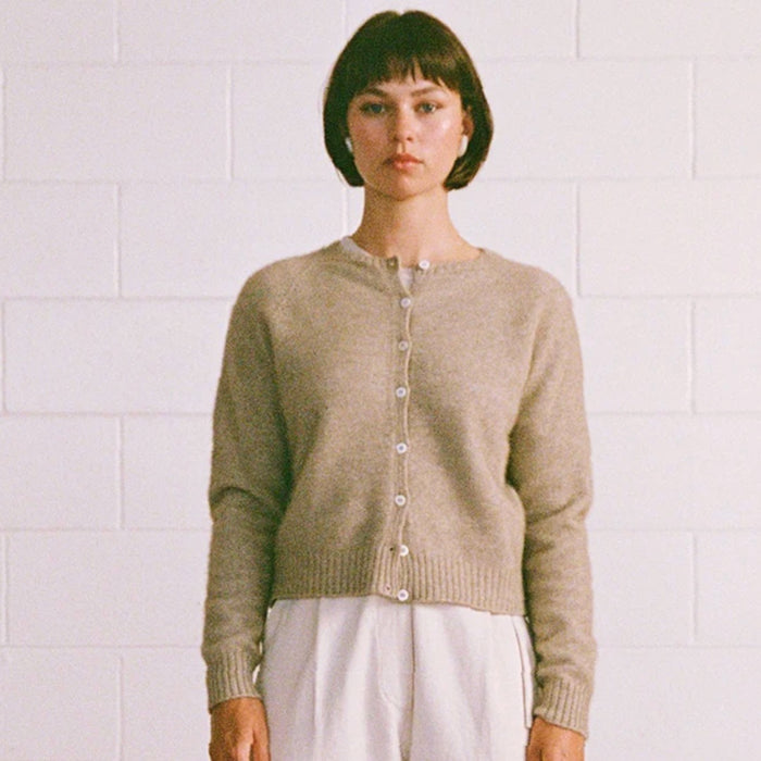 Francie Dusk cardigan in natural, a crew neck button-front knit cardigan worn with white trousers