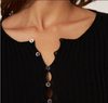 Francie Form ribbed merino henley top in black, close-up of the shell buttons