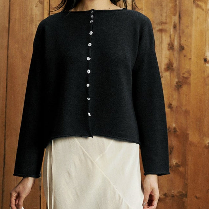 Francie Heirloom button doll’s cardigan in black, a cropped knit cardigan with mismatched mother-of-pearl buttons