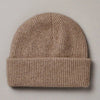 Francie Hinoki beanie in natural, a ribbed knit beanie with fold-up cuff, laid flat