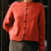 Francie Loft merino wool cardigan in amber rust, front view showing tortoiseshell buttons and ribbed hem
