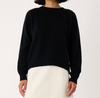 Francie Nimbus crew neck knit jumper in black, worn with a cream skirt