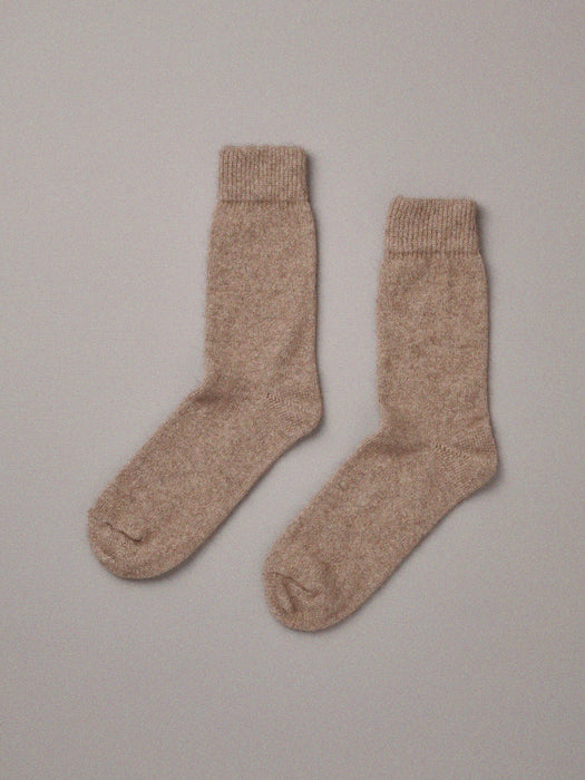 Natural coloured possum merino socks on plain background