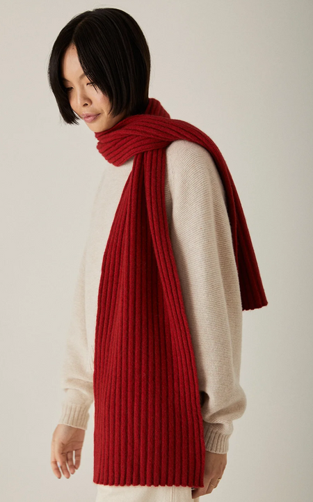 Francie Umbra merino possum scarf in poppy red, long rib knit worn over a cream jumper