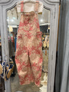 Free People Good Luck barrel overalls in pink lotus floral print, on a hanger