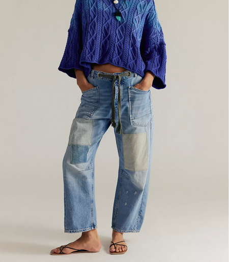 Free People Moxie low slung jeans in faded blue denim with patches, worn front