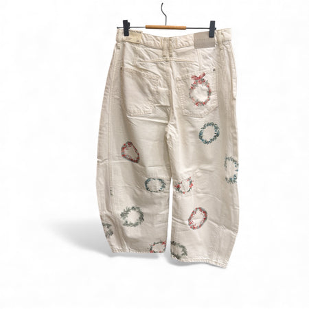 Free People cream wreath embroidered barrel jeans on a hanger, back view