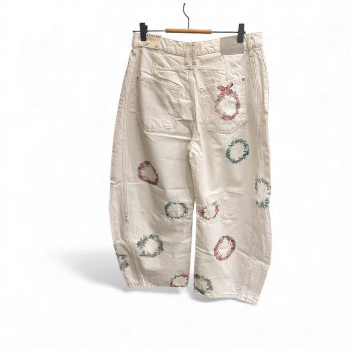 Free People cream wreath embroidered barrel jeans on a hanger, back view