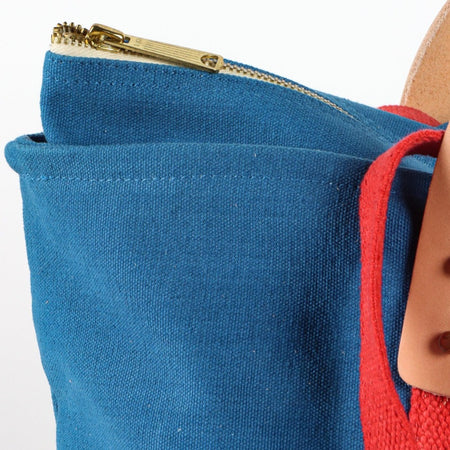 Immodest Cotton zippered canvas lunch bag, close-up of the brass top zip and red webbing handle