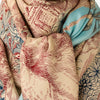 Inouitoosh Piranesi large square scarf draped and knotted, showing the red toile engraving print