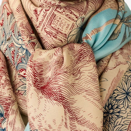 Inouitoosh Piranesi large square scarf draped and knotted, showing the red toile engraving print