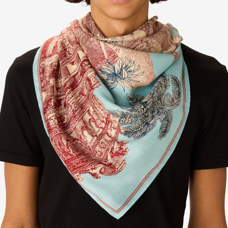 Inouitoosh Piranesi large square scarf worn at the neck, red and blue architectural toile print on aqua