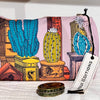 Inouitoosh Tequila grapefruit cactus print pouch with Inoui Editions tag and a vintage tin