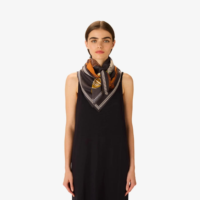Model wearing the Inouitoosh Tequila lemon square scarf knotted at the neck