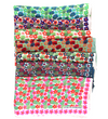Les Belles Vagabondes Capucine silk scarves folded in a stack, showing several colourways