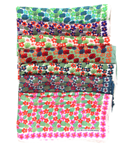 Les Belles Vagabondes Capucine silk scarves folded in a stack, showing several colourways