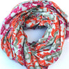 Les Belles Vagabondes large cotton scarf in orange, pink and sage print, loosely coiled