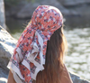 Les Belles Vagabondes Heidi cotton square scarf in pink and navy print, worn as a headscarf