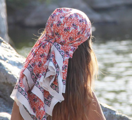 Les Belles Vagabondes Heidi cotton square scarf in pink and navy print, worn as a headscarf