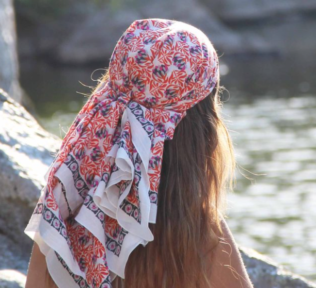 Les Belles Vagabondes Heidi cotton square scarf in pink and navy print, worn as a headscarf