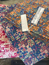 Les Belles Vagabondes Malmo cotton square scarves stacked in store, blue and pink colourways