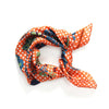 Les Belles Vagabondes mini shippo silk neckerchief in orange, tied in a knot