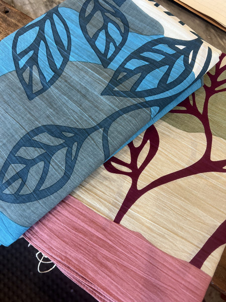 Les Belles Vagabondes Palenque cotton square scarves in blue and rose pink, folded in store