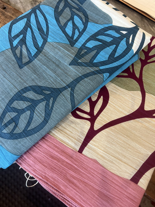 Les Belles Vagabondes Palenque cotton square scarves in blue and rose pink, folded in store