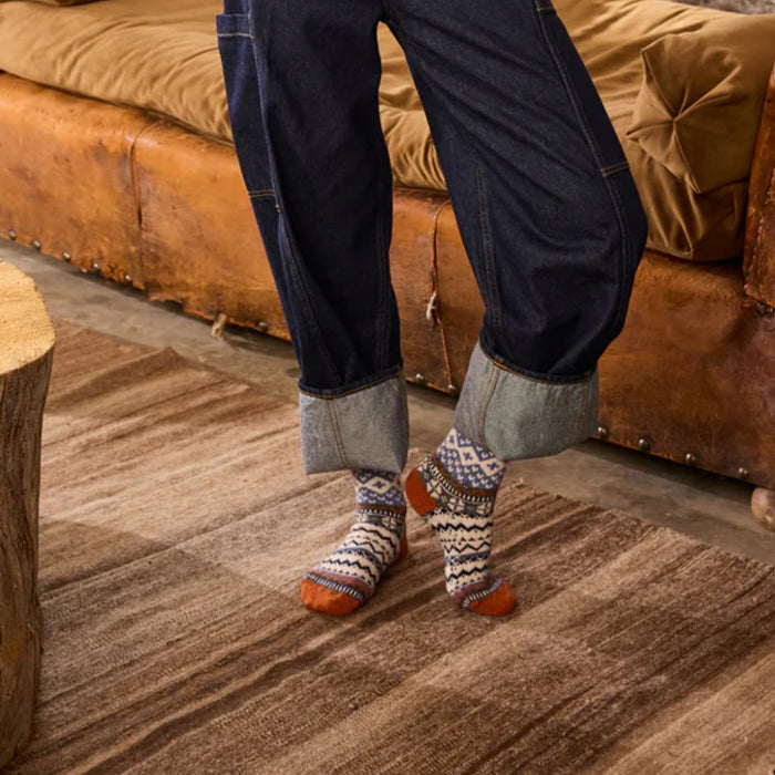 Model wearing Lisa B Fairisle wool cashmere crew socks in pumpkin with rolled denim jeans