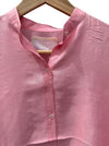 Close-up of the mandarin collar and buttons on the LOOM pink silk shirt