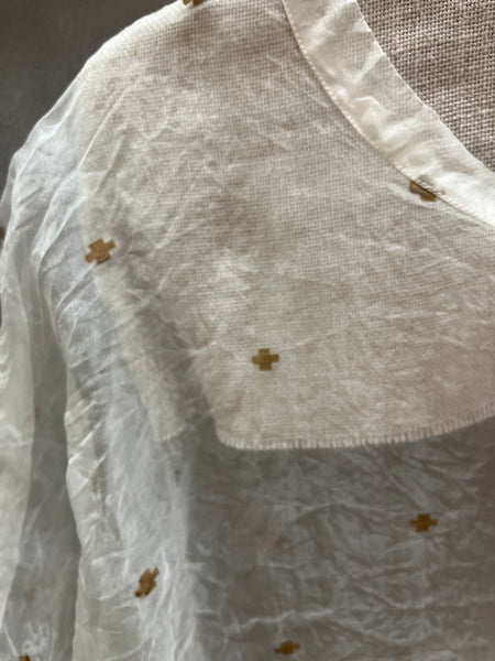 LOOM organza dress close-up of the khaki cross embroidery and neckline