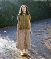 Metta Melbourne Ash A-line skirt in coco stripe, worn outdoors with an olive top