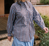 Metta Melbourne Italy shirt in blue and coco stripe, worn outdoors
