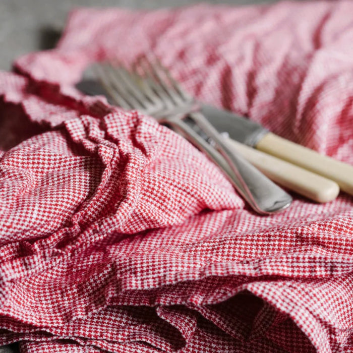 Metta Melbourne red houndstooth linen tea towel, crumpled with vintage cutlery