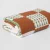 Nancybird geo patchwork kantha quilt folded, showing the hand stitching and printed patches