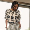 Model wearing the Nancybird Maha shirred blouse in cream and black floral