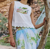 Model wearing the Nancybird Moa white tank top with a printed skirt, outdoors