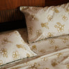Nancybird tea tree print pillow cases on a bed with matching sheets