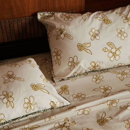Nancybird tea tree print pillow cases on a bed with matching sheets