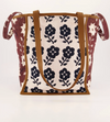 Nancybird tote bag in navy and burgundy floral print with tan leather handles