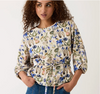 Model wearing the Nancybird Zephyr blouse in cream and blue floral print