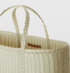 Wicker basket with a handle on a light background