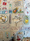 Rebecca Manning hand stitched baby quilt on a dotty background, alternate view