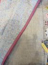 Rebecca Manning hand stitched baby quilt on a dotty background, alternate view