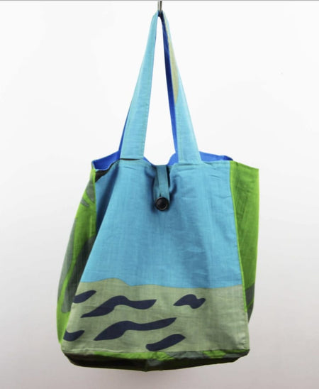 Tote bag with blue and green design on a white background
